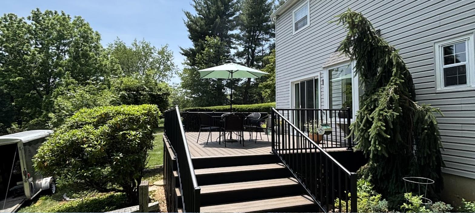 Custom deck build with multi-level stairs and seating area by RC Deck Co